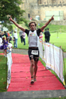 Alun Woodward from Hungary wins the Bamburgh Triathlon with Alnwick Castle as a backdrop